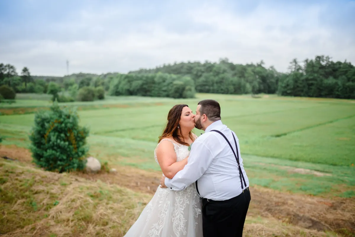 A couple shares a kiss overlooking the cranberry bogs
